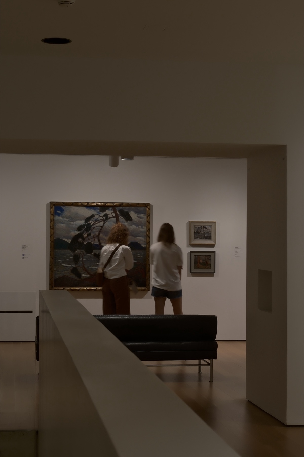 Two visitors before Tom Thomson's The West Wind