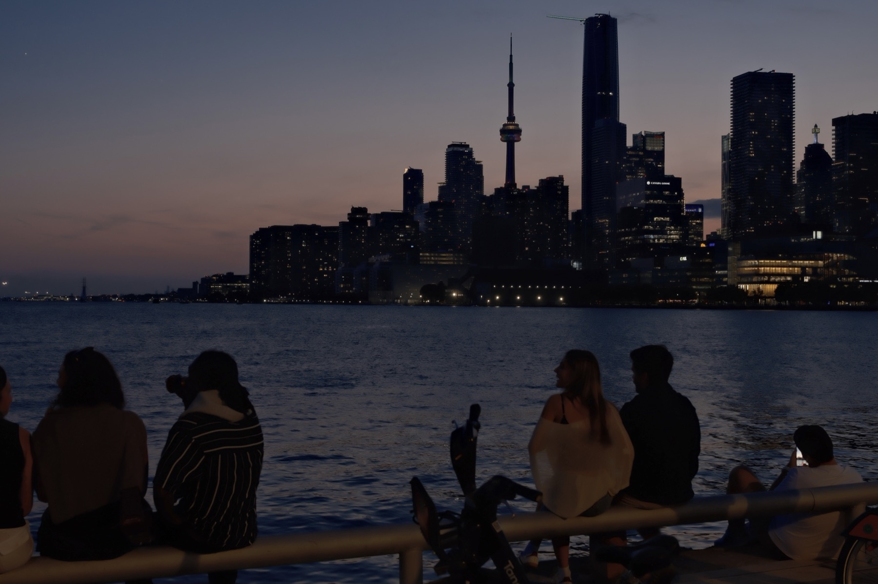 The city's lights coming on across the water — That Will No Longer Happen