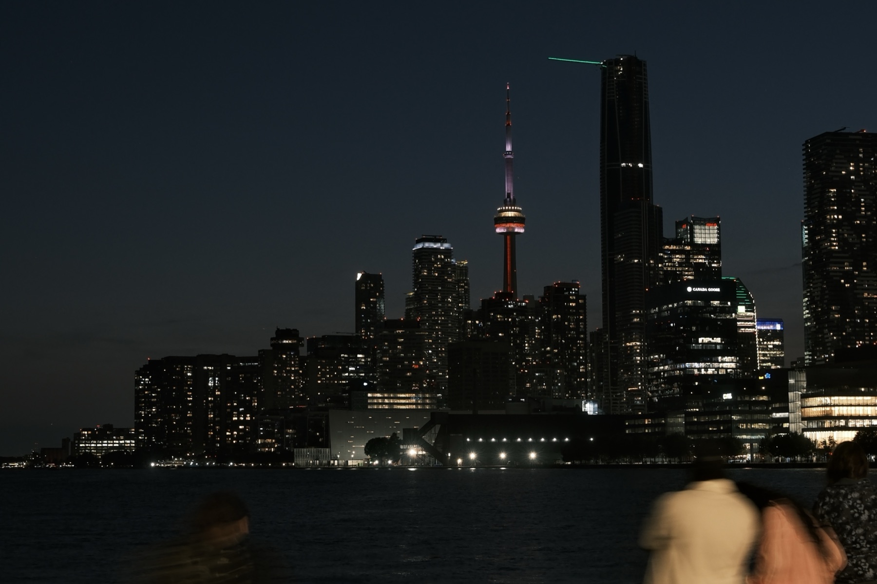 The night skyline, a couple blurring past in the foreground