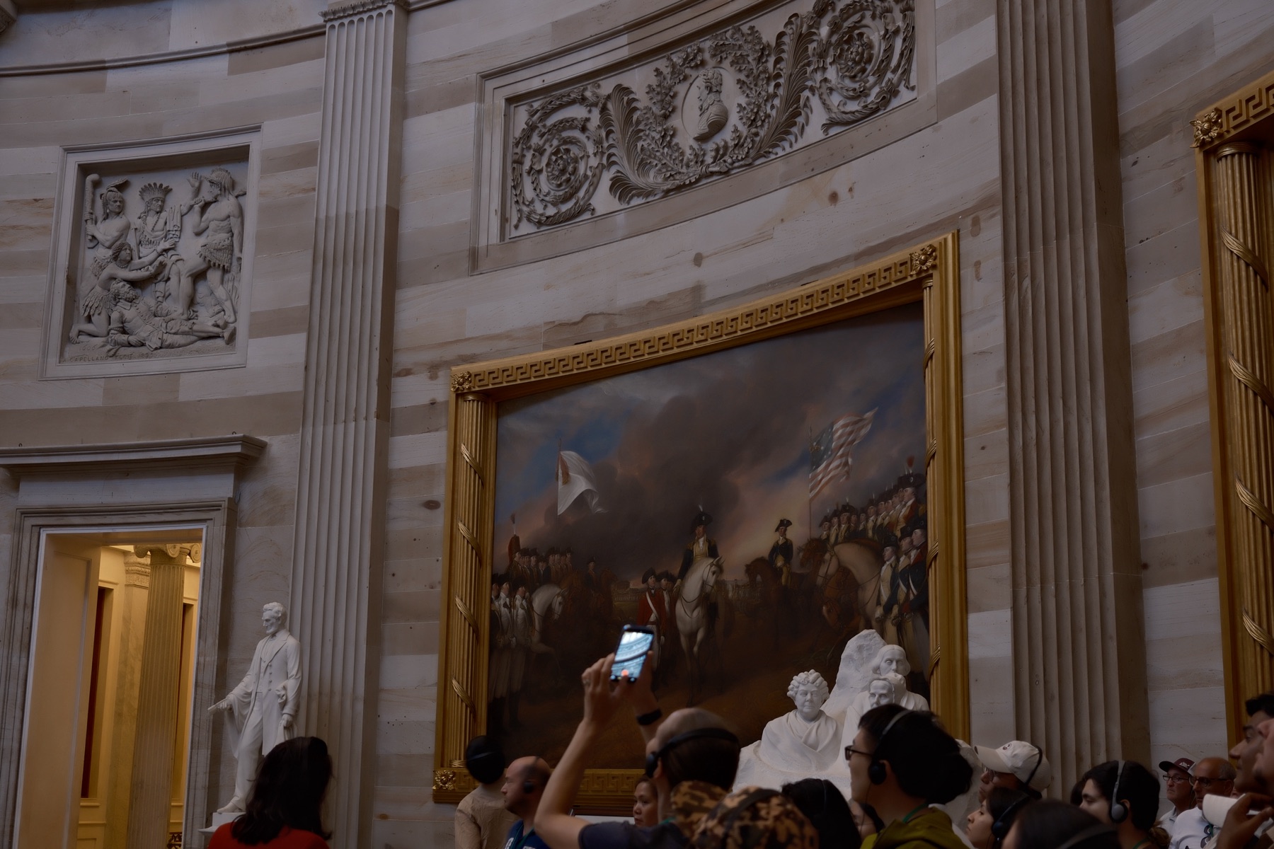 Visitors photographing the paintings
