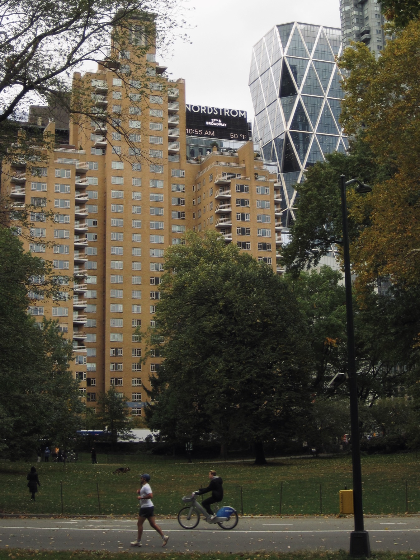 A runner and a bike passing beneath the towers