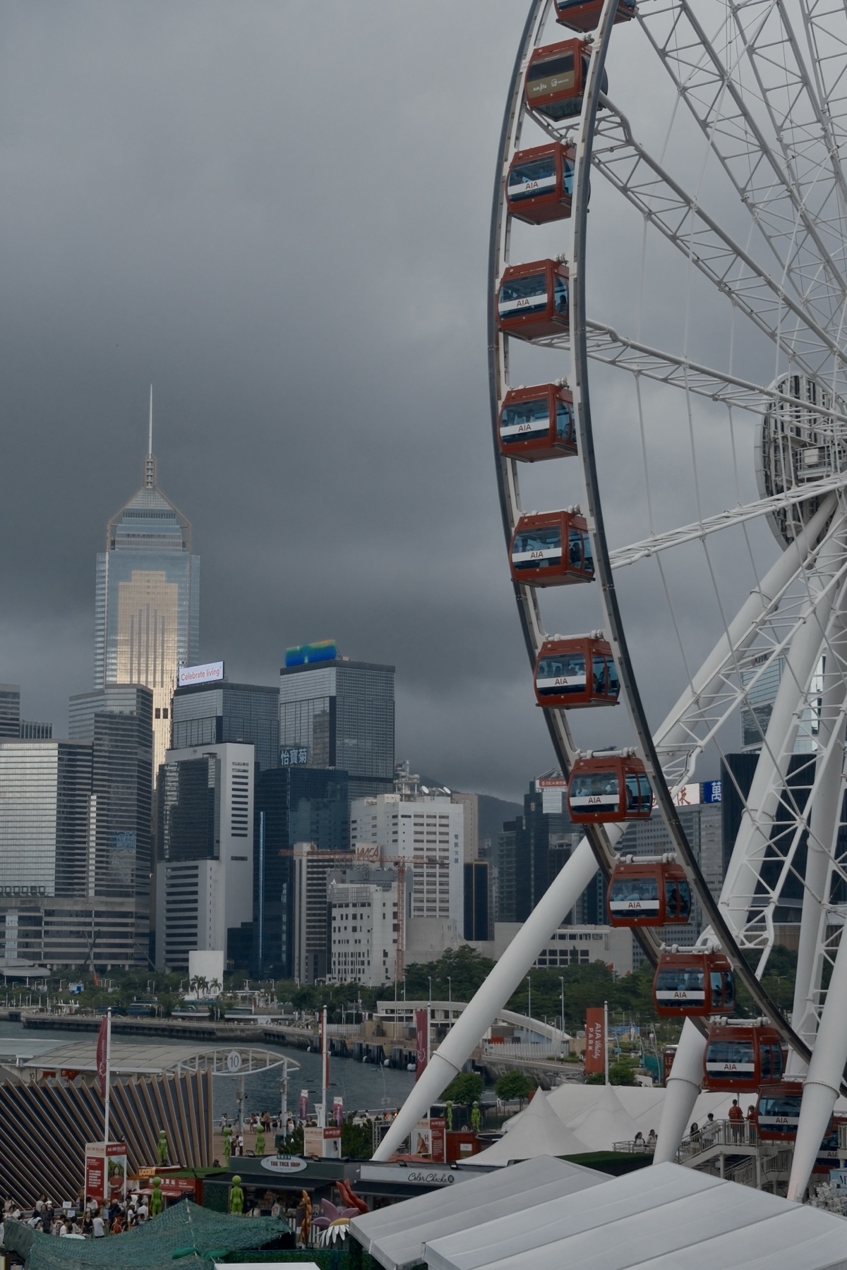 The white observation wheel against a dark storm sky