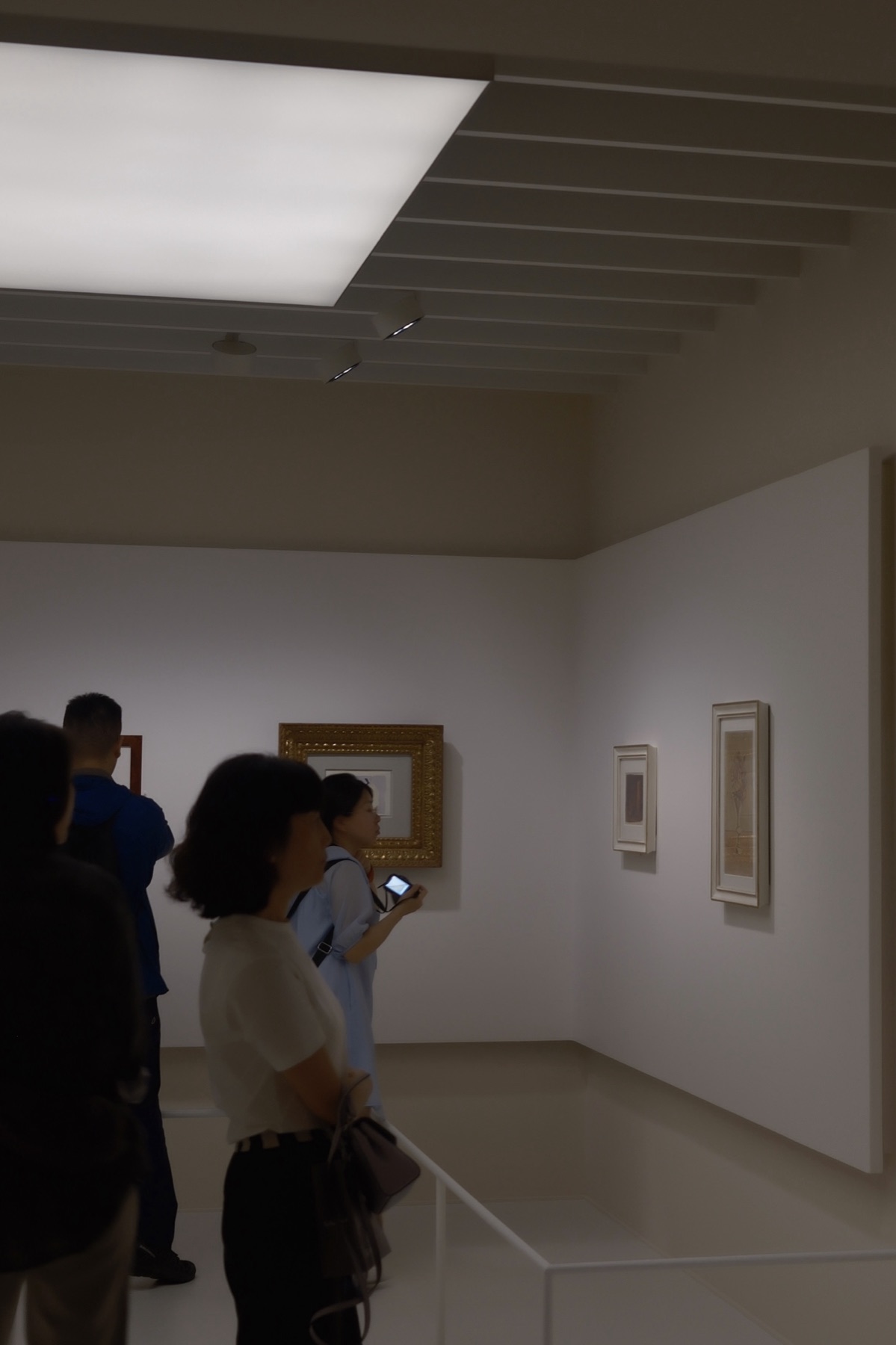 Visitors gathered under the lit ceiling of the Morandi rooms