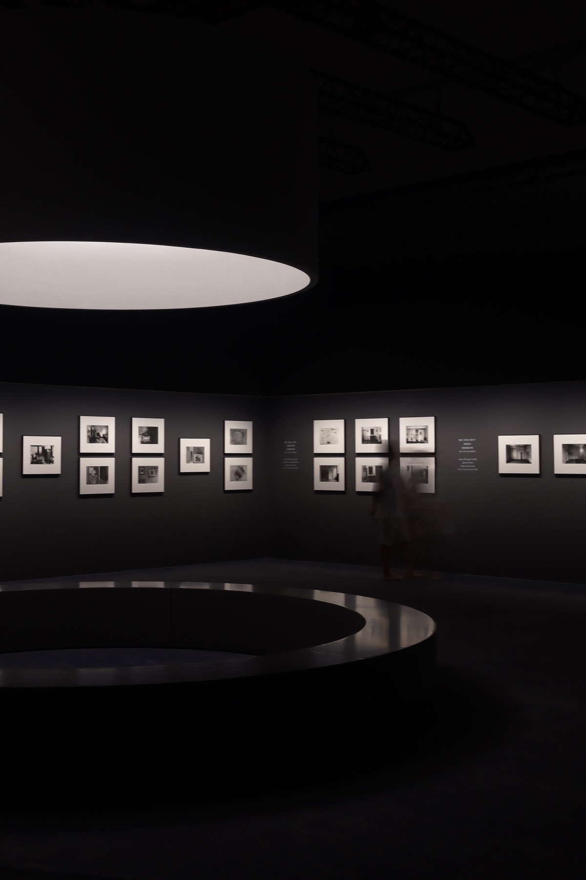 Gardin's silver prints on dark walls under a great drum of light