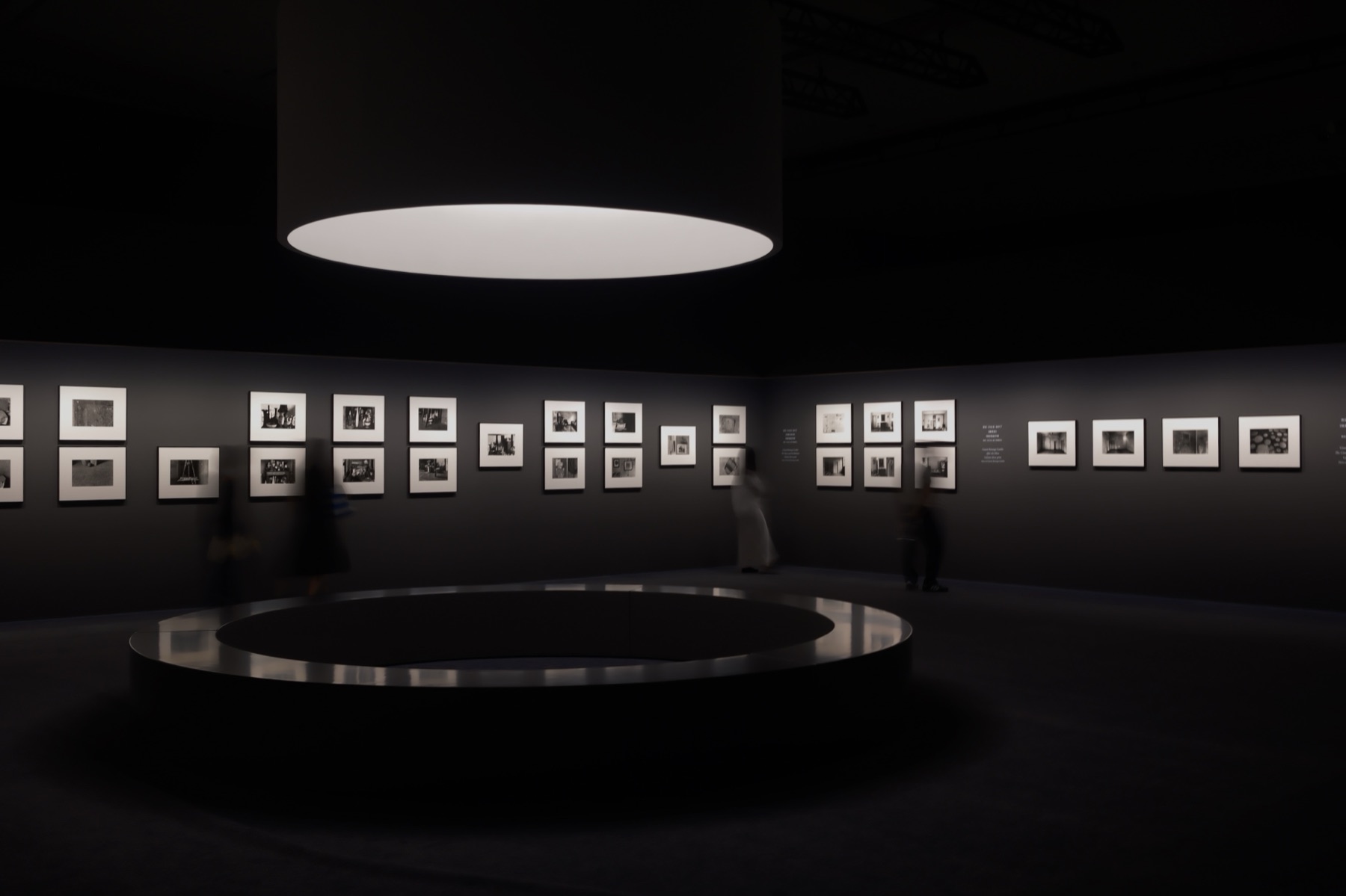 The dark Gardin room, white-matted photographs and ghosted visitors