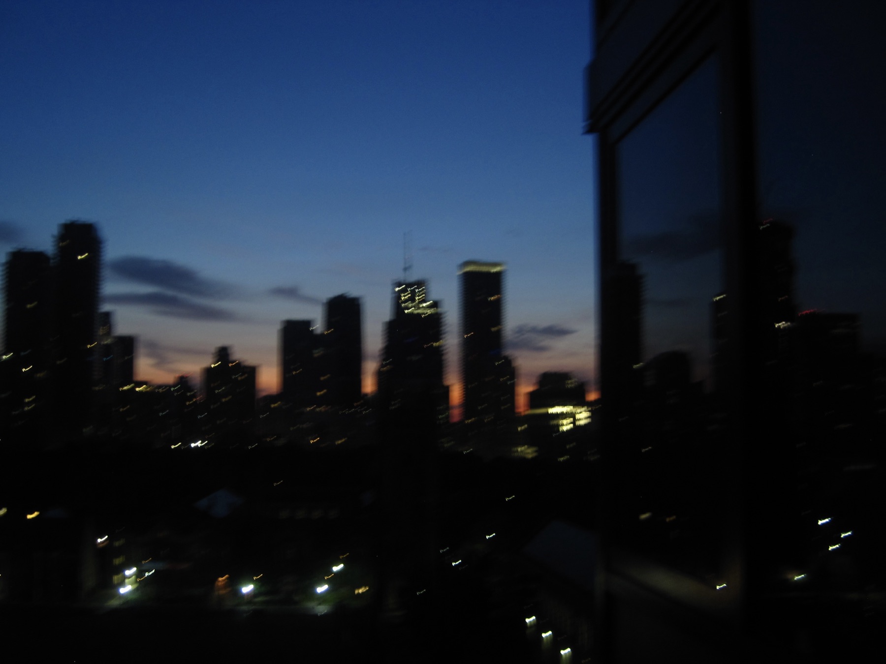 The skyline at blue dawn with a thin pink band along the horizon