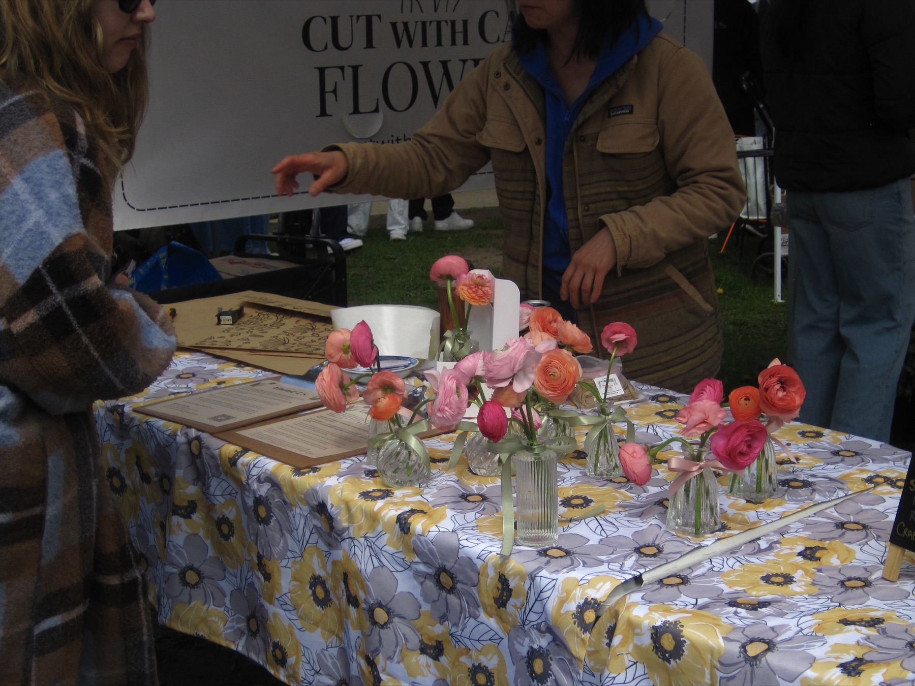 Ranunculus in little bottles at a stand