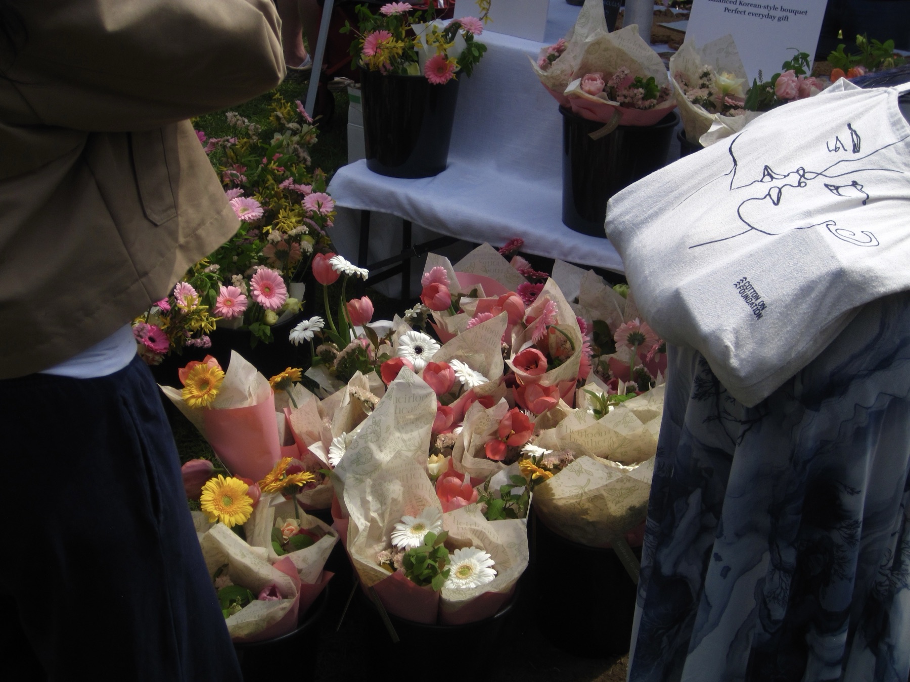 Wrapped cones of daisies and tulips