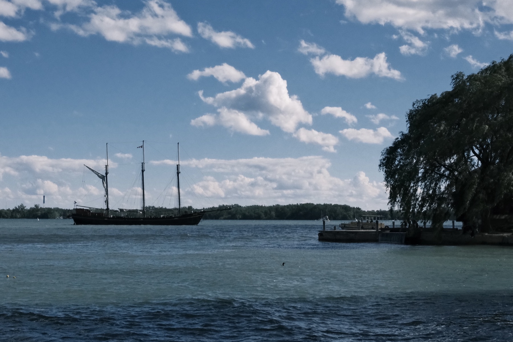A tall ship idling on the lake
