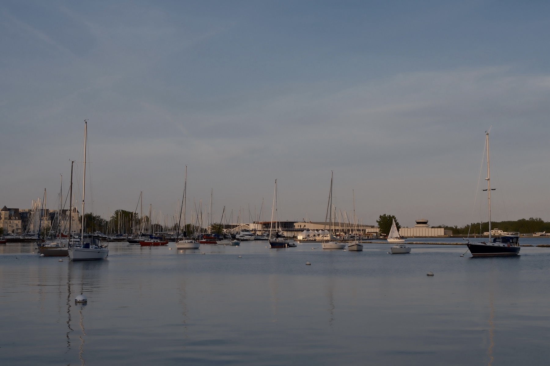 A marina full of masts on pewter water