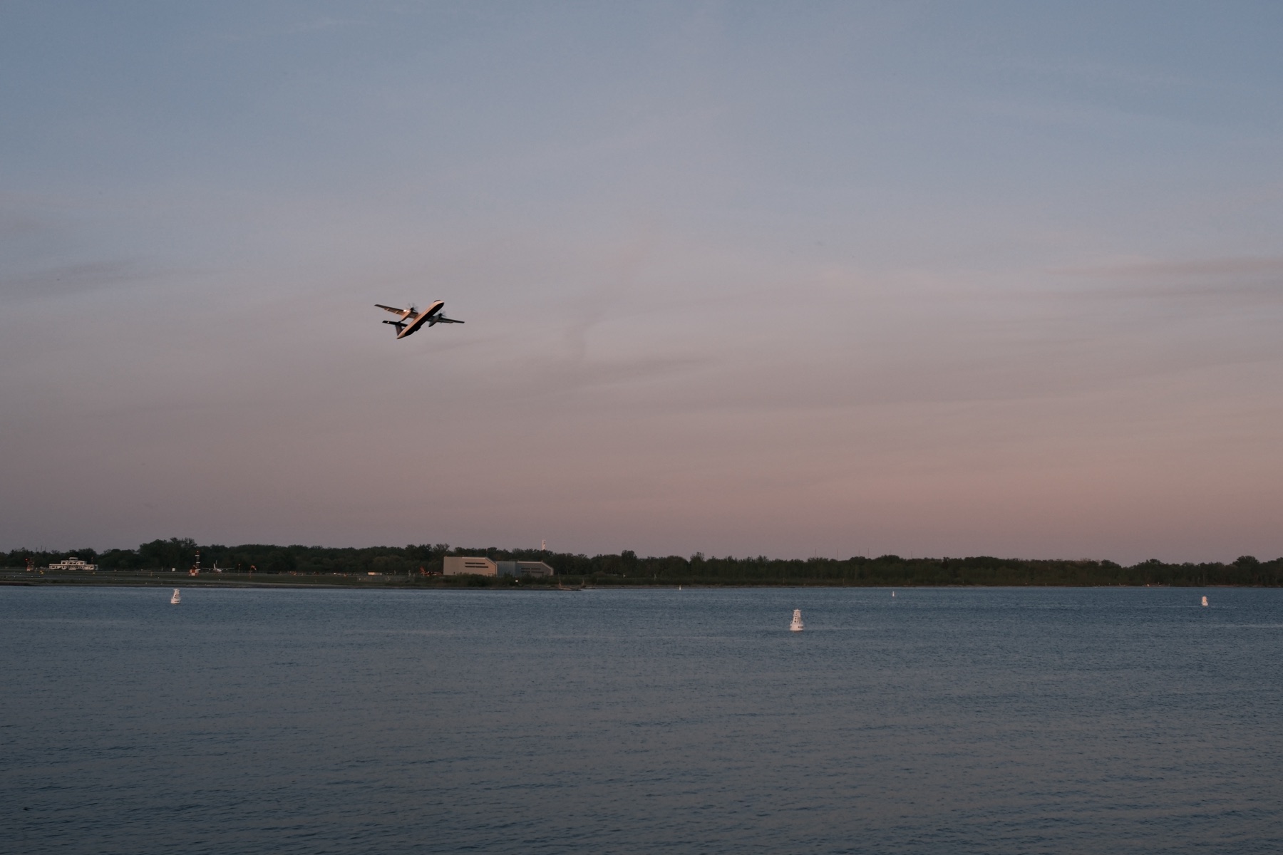 A plane against a pink evening sky