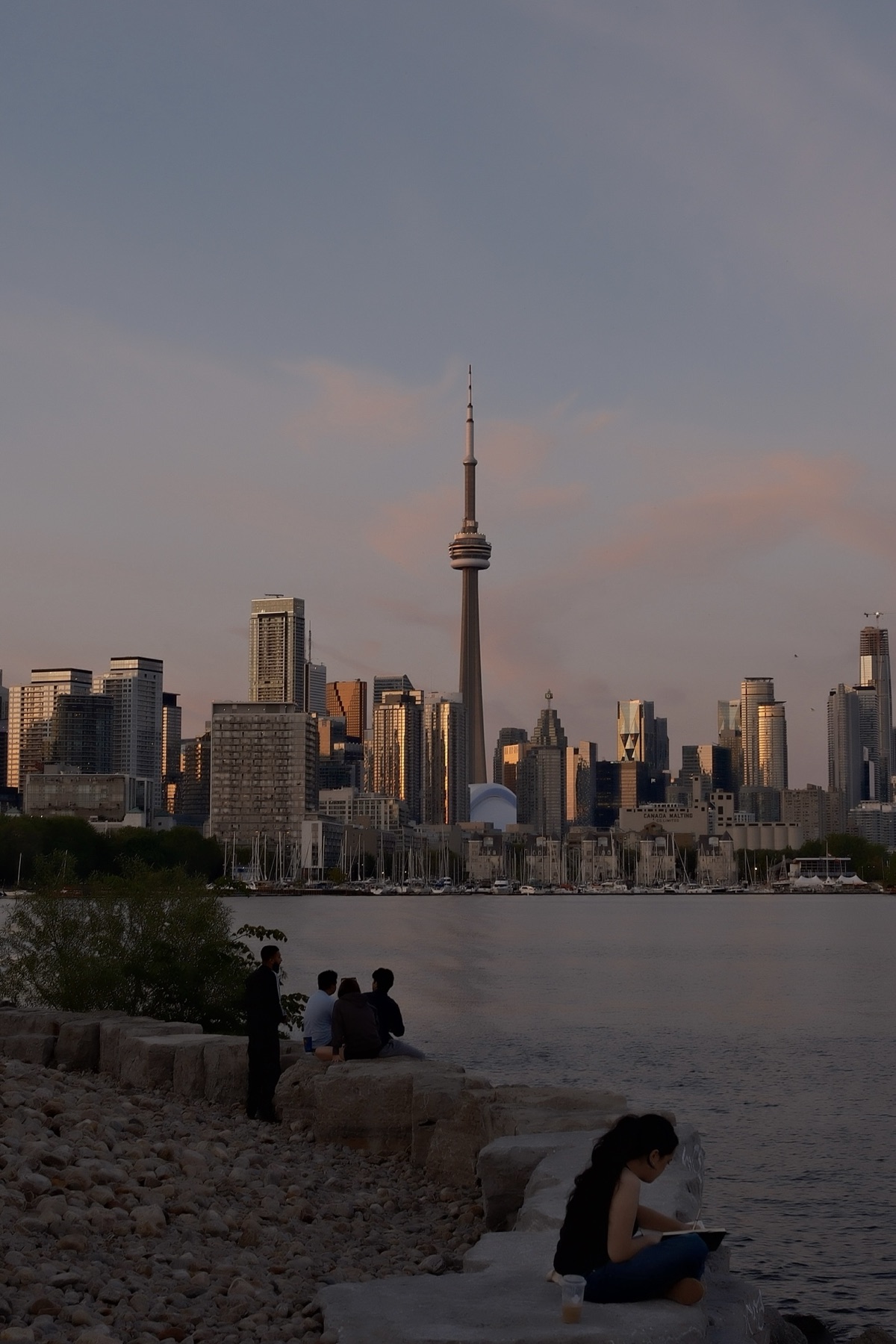 People on the rocks, one reading as the towers turn rose