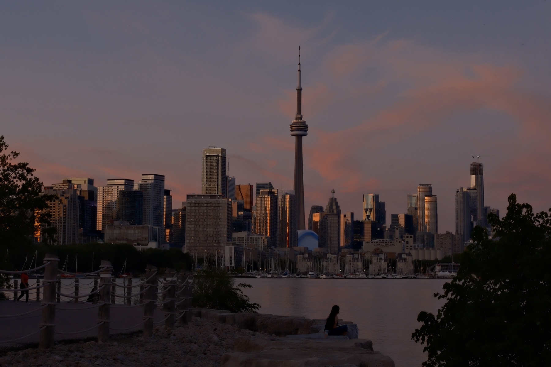 The skyline stacked under a single pink cloud