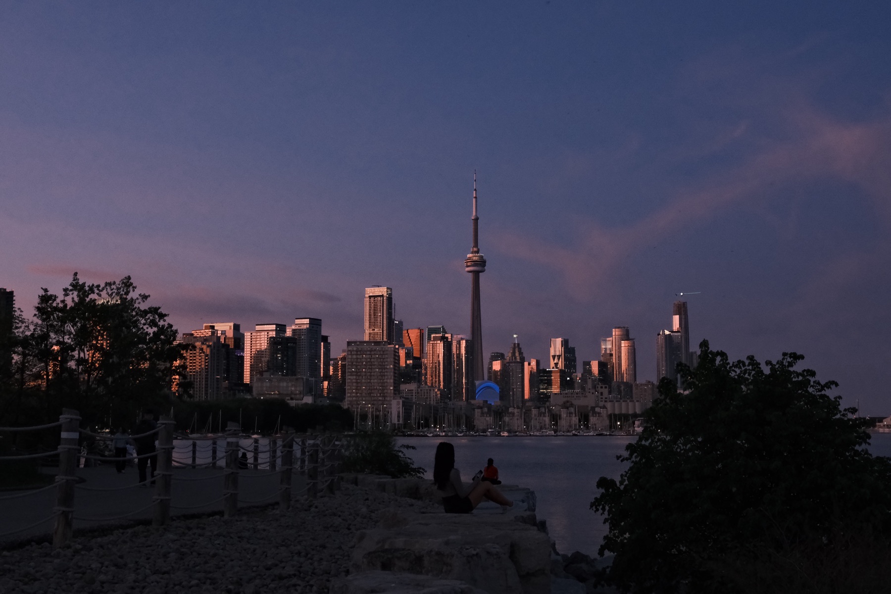 The skyline holding the day's last glow from the shore