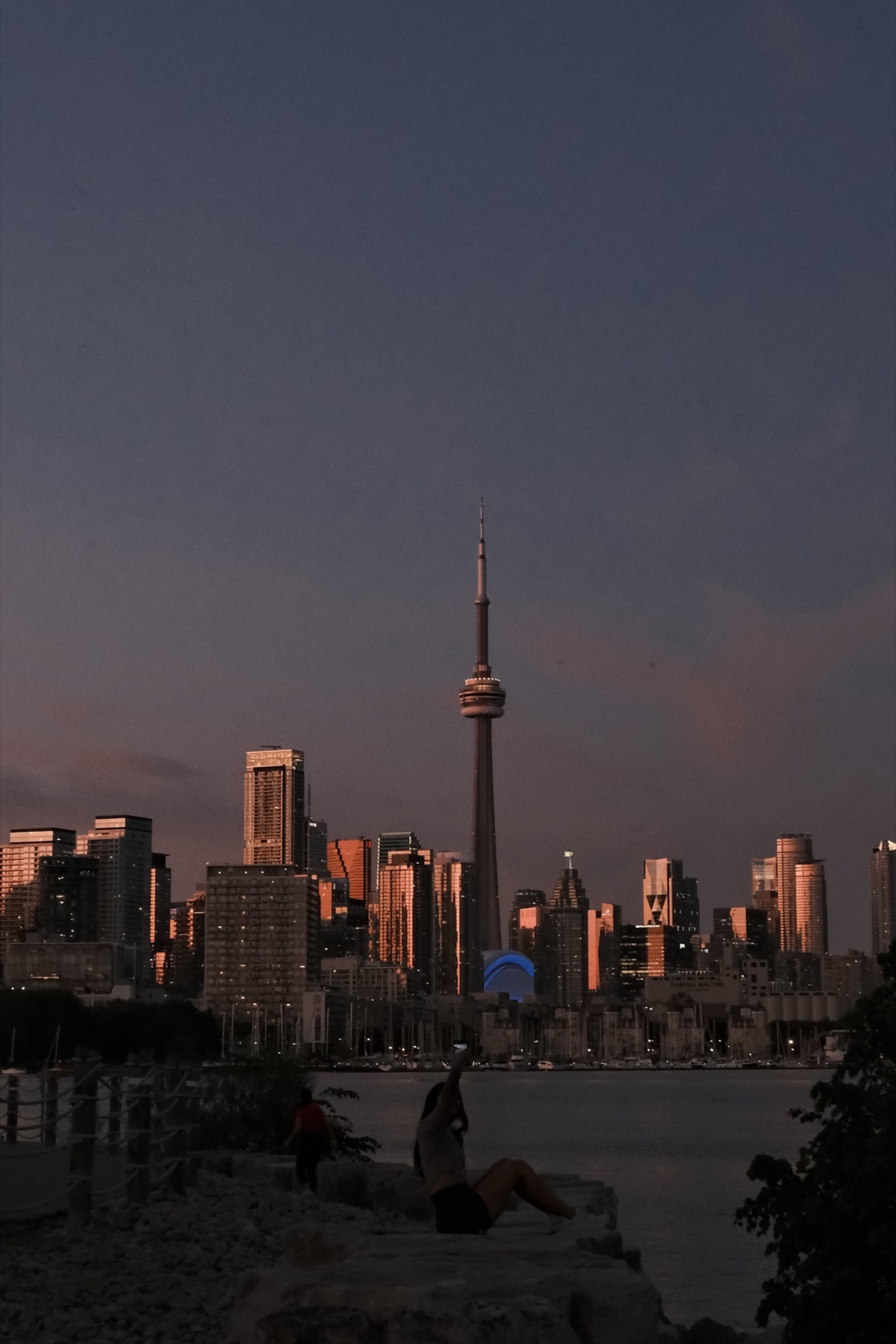 The lit towers over an almost-black lake